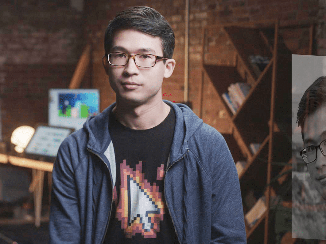 Alan, posing in a brick-walled room.